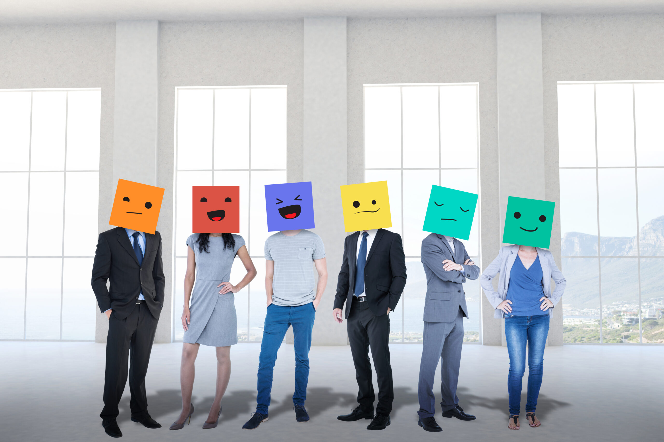 Diverse team wearing colorful emotion-themed boxes representing personality traits—illustrating personality testing in the workplace and the role of AI in employee experience and leadership development.
